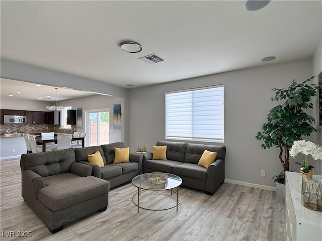 9604 Vital Crest St, Las Vegas, NV 89123 - living area with light wood finished floors and a chandelier