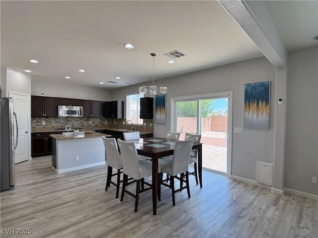 9604 Vital Crest St, Las Vegas, NV 89123 - dining room featuring light wood-type flooring, recessed lighting, and a chandelier