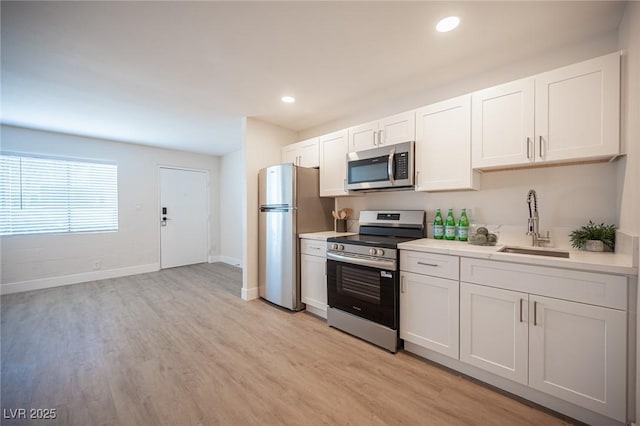 4600 University Center Dr Unit 72, Las Vegas, NV 89119 - kitchen with stainless steel appliances, light countertops, light wood finished floors, white cabinets, and recessed lighting