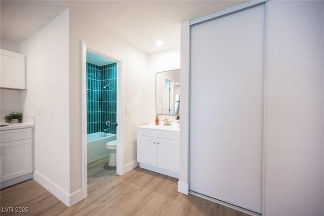4600 University Center Dr Unit 72, Las Vegas, NV 89119 - bathroom with vanity, wood finished floors, shower / bathtub combination, and recessed lighting