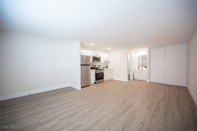4600 University Center Dr Unit 72, Las Vegas, NV 89119 - unfurnished living room with light wood-style floors and recessed lighting