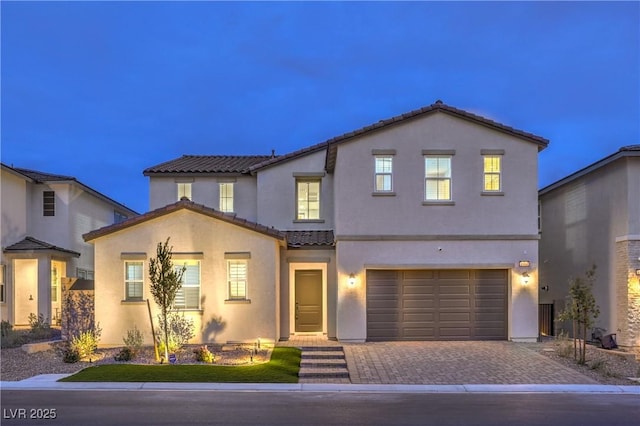 8984 Rolling Pietra St, Las Vegas, NV 89166 - view of front facade featuring a tile roof, stucco siding, a garage, and decorative driveway