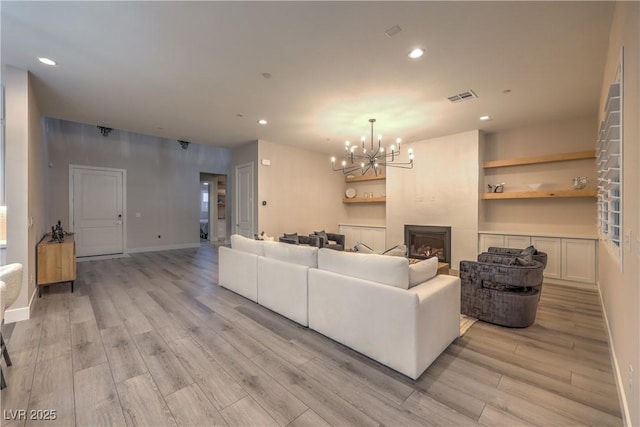 8984 Rolling Pietra St, Las Vegas, NV 89166 - living area featuring a chandelier, recessed lighting, light wood finished floors, and a fireplace