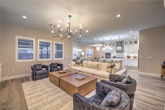8984 Rolling Pietra St, Las Vegas, NV 89166 - living room featuring a chandelier, light wood-style flooring, and recessed lighting