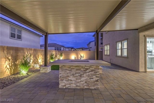 8984 Rolling Pietra St, Las Vegas, NV 89166 - fenced backyard with an outdoor fire pit and a patio area