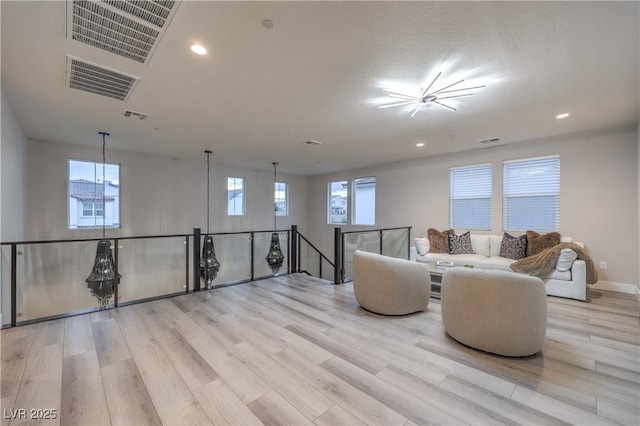 8984 Rolling Pietra St, Las Vegas, NV 89166 - living room with light wood-style floors, recessed lighting, and a chandelier