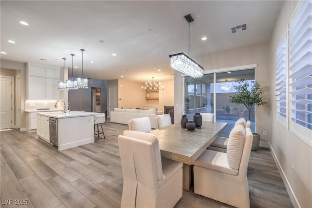 8984 Rolling Pietra St, Las Vegas, NV 89166 - dining room with a chandelier, recessed lighting, and light wood-style floors