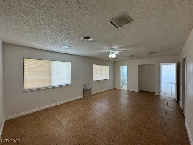 4200 Via Vaquero Ave, Las Vegas, NV 89102 - tiled empty room featuring ceiling fan and a textured ceiling