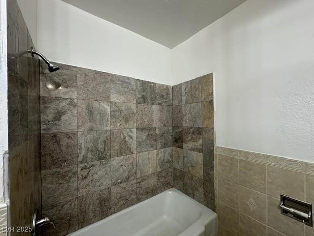 4200 Via Vaquero Ave, Las Vegas, NV 89102 - bathroom featuring tile walls and shower / bathtub combination