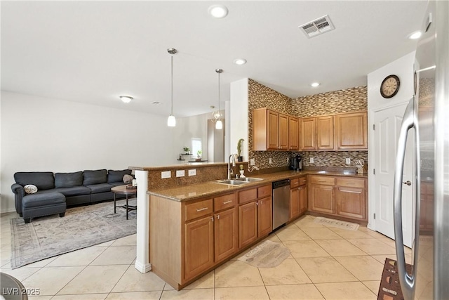 9004 Harbor Wind Ave, Las Vegas, NV 89178 - kitchen featuring stainless steel appliances, light tile patterned floors, open floor plan, backsplash, and decorative light fixtures