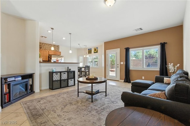 9004 Harbor Wind Ave, Las Vegas, NV 89178 - living room with plenty of natural light, light tile patterned floors, recessed lighting, and a glass covered fireplace