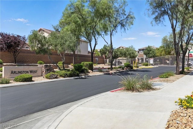 9004 Harbor Wind Ave, Las Vegas, NV 89178 - view of asphalt road with sidewalks, a residential view, curbs, and a gated entry