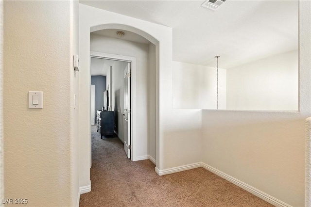 9004 Harbor Wind Ave, Las Vegas, NV 89178 - corridor featuring carpet flooring and arched walkways
