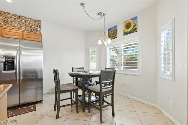 9004 Harbor Wind Ave, Las Vegas, NV 89178 - dining room featuring healthy amount of natural light, light tile patterned floors, and a chandelier