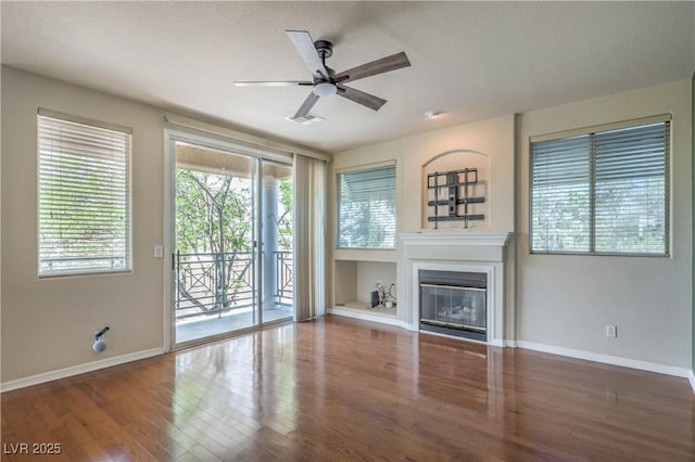 801 Dana Hills Ct Unit 101, Las Vegas, NV 89134 - unfurnished living room featuring ceiling fan, wood finished floors, and a glass covered fireplace