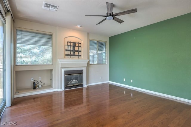 801 Dana Hills Ct Unit 101, Las Vegas, NV 89134 - unfurnished living room with ceiling fan, a glass covered fireplace, and wood finished floors