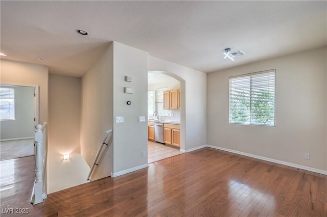 801 Dana Hills Ct Unit 101, Las Vegas, NV 89134 - unfurnished room with light wood-type flooring, plenty of natural light, and arched walkways