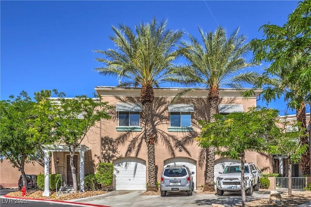 801 Dana Hills Ct Unit 101, Las Vegas, NV 89134 - view of front of house featuring a garage, driveway, and stucco siding