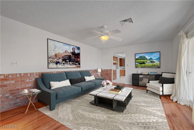 1705 Westwind Rd, Las Vegas, NV 89146 - living area with wood finished floors, a textured ceiling, and a ceiling fan