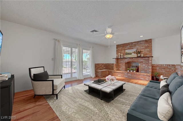 1705 Westwind Rd, Las Vegas, NV 89146 - living area with a textured ceiling, ceiling fan, wood finished floors, a fireplace, and recessed lighting