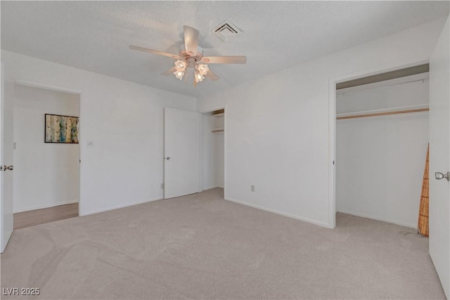 1705 Westwind Rd, Las Vegas, NV 89146 - unfurnished bedroom with carpet, multiple closets, ceiling fan, and a textured ceiling