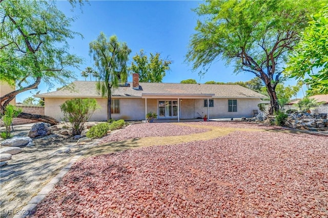 1705 Westwind Rd, Las Vegas, NV 89146 - view of front of house featuring a chimney, stucco siding, and french doors