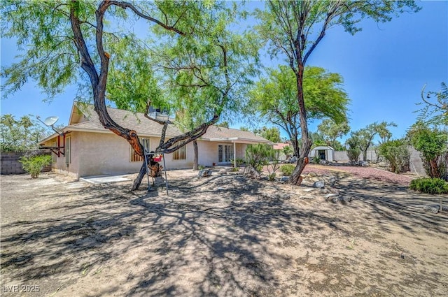 1705 Westwind Rd, Las Vegas, NV 89146 - ranch-style house featuring a fenced backyard, a shed, stucco siding, and french doors
