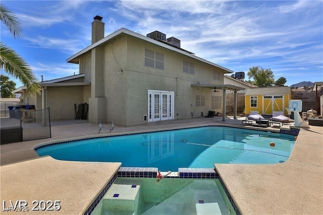 722 Barrie Ct, Henderson, NV 89002 - view of pool with french doors, a storage shed, a patio area, and a pool with connected hot tub
