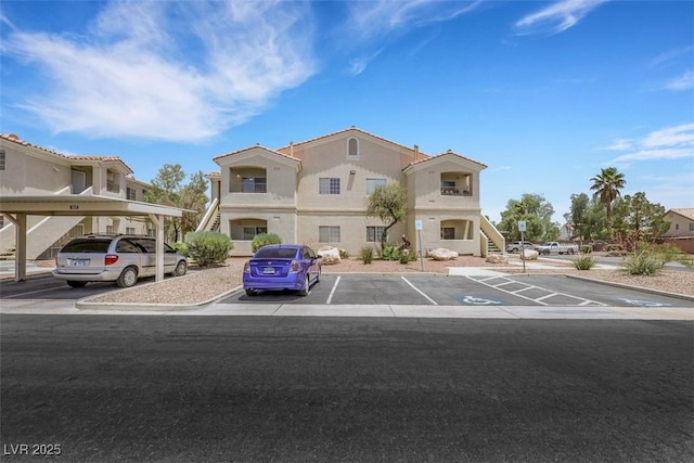 1881 W Alexander Rd Unit 2093, North Las Vegas, NV 89032 - multi unit property with covered and uncovered parking, stairway, and stucco siding