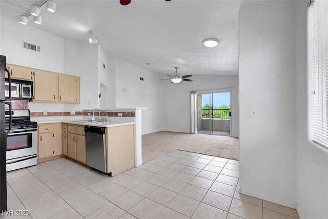 1881 W Alexander Rd Unit 2093, North Las Vegas, NV 89032 - kitchen with appliances with stainless steel finishes, ceiling fan, light brown cabinetry, a peninsula, and light carpet