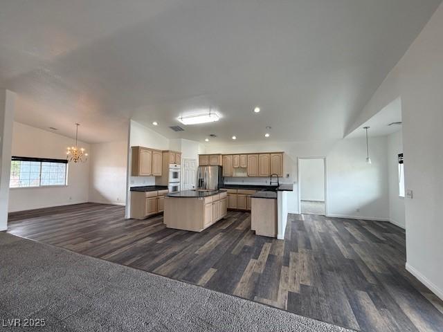 1830 Justine Ct, Pahrump, NV 89048 - kitchen with open floor plan, stainless steel refrigerator with ice dispenser, dark countertops, lofted ceiling, and a chandelier