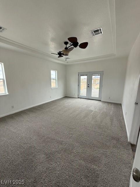 1830 Justine Ct, Pahrump, NV 89048 - carpeted spare room featuring a tray ceiling, a ceiling fan, and french doors