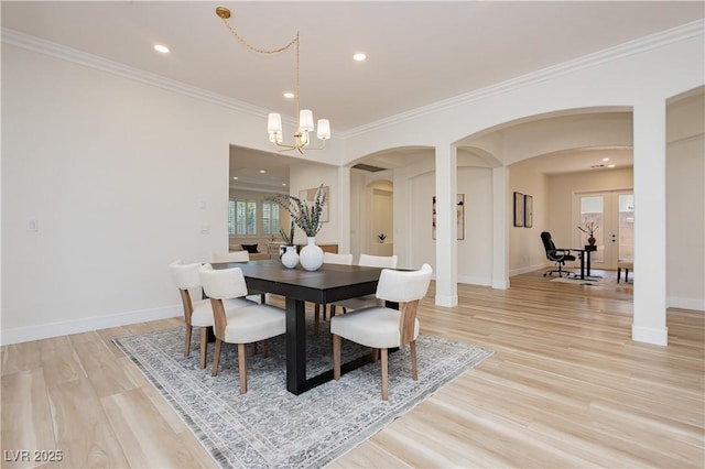 4493 Rometta Ave, Las Vegas, NV 89141 - dining room featuring arched walkways, light wood-style floors, a chandelier, healthy amount of natural light, and ornamental molding