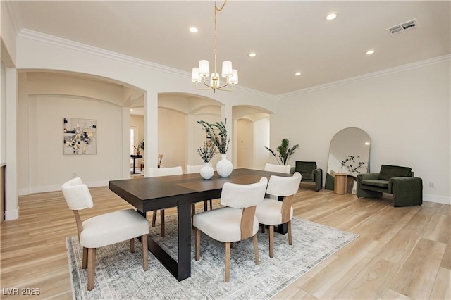 4493 Rometta Ave, Las Vegas, NV 89141 - dining area featuring arched walkways, a chandelier, ornamental molding, light wood-style flooring, and recessed lighting