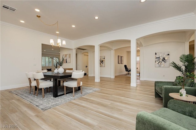 4493 Rometta Ave, Las Vegas, NV 89141 - dining room with arched walkways, ornamental molding, light wood-style flooring, recessed lighting, and a chandelier