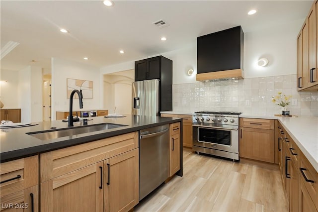 4493 Rometta Ave, Las Vegas, NV 89141 - kitchen featuring stainless steel appliances, extractor fan, backsplash, recessed lighting, and light wood finished floors