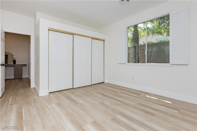 4493 Rometta Ave, Las Vegas, NV 89141 - unfurnished bedroom with light wood-style floors and a closet