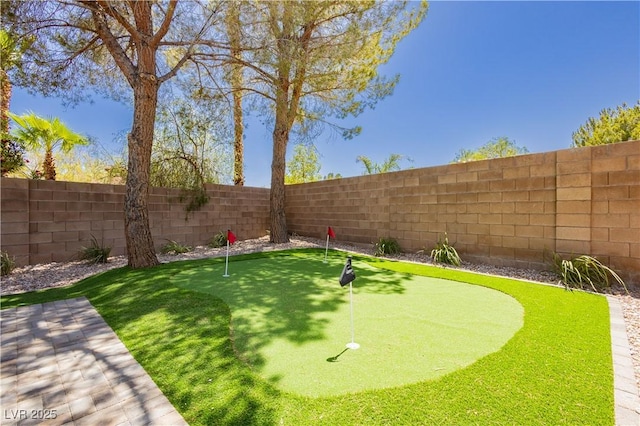 4493 Rometta Ave, Las Vegas, NV 89141 - fenced backyard with an area to practice putting