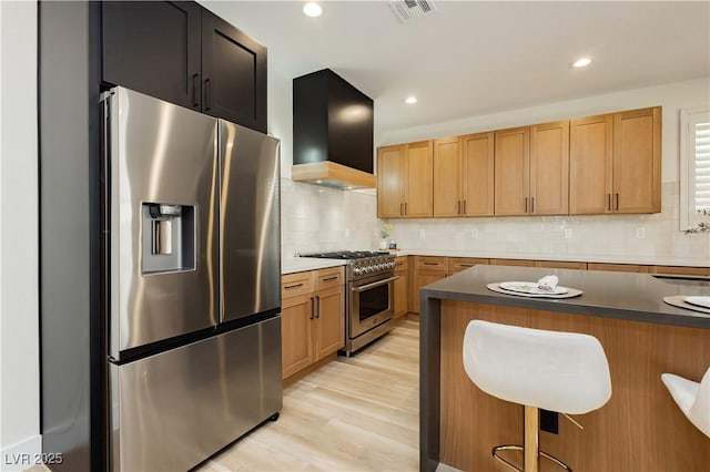 4493 Rometta Ave, Las Vegas, NV 89141 - kitchen with appliances with stainless steel finishes, premium range hood, tasteful backsplash, a breakfast bar, and recessed lighting