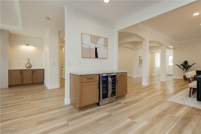4493 Rometta Ave, Las Vegas, NV 89141 - indoor dry bar featuring wine cooler, arched walkways, light wood-style flooring, ornamental molding, and recessed lighting