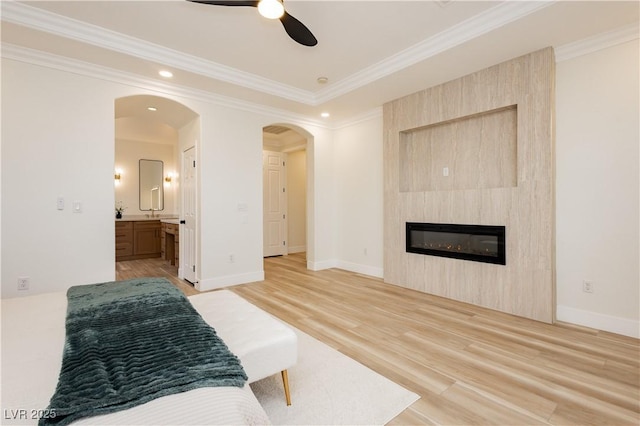 4493 Rometta Ave, Las Vegas, NV 89141 - bedroom with light wood finished floors, arched walkways, ornamental molding, a fireplace, and ensuite bathroom