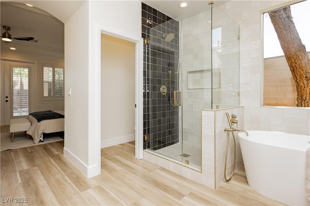 4493 Rometta Ave, Las Vegas, NV 89141 - full bath featuring a shower stall, a freestanding bath, wood finished floors, ceiling fan, and ensuite bathroom