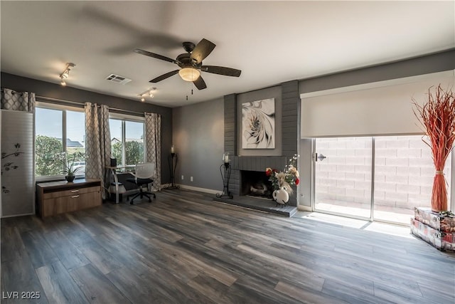 4129 Ridgewood Ave, Las Vegas, NV 89120 - home office with a ceiling fan, a fireplace, dark wood-type flooring, and track lighting