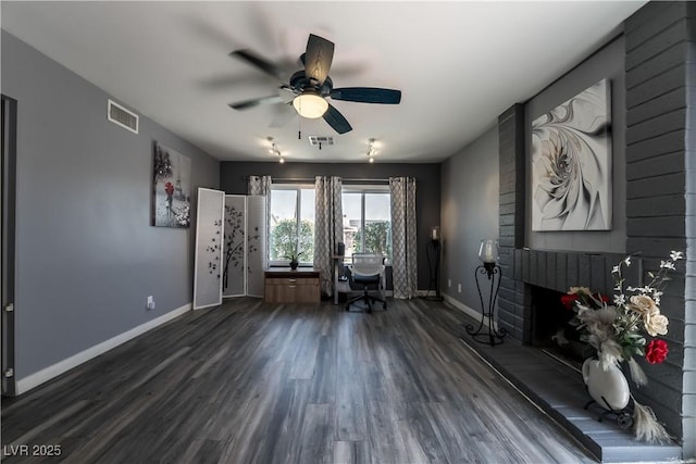 4129 Ridgewood Ave, Las Vegas, NV 89120 - office area with dark wood-style flooring, ceiling fan, and a brick fireplace