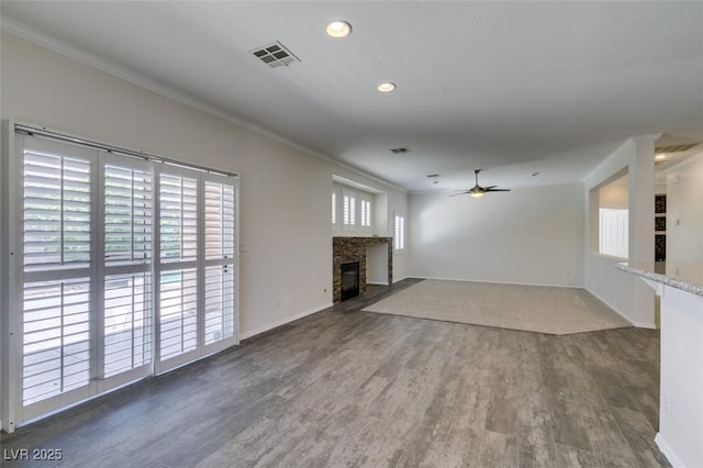 1453 Doggett Ave, Las Vegas, NV 89123 - unfurnished living room with crown molding, a ceiling fan, wood finished floors, a stone fireplace, and recessed lighting