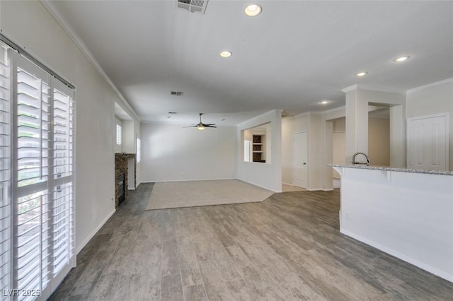 1453 Doggett Ave, Las Vegas, NV 89123 - unfurnished living room with crown molding, wood finished floors, a ceiling fan, recessed lighting, and a glass covered fireplace