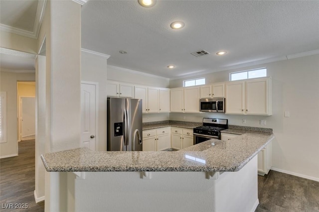 1453 Doggett Ave, Las Vegas, NV 89123 - kitchen featuring stainless steel appliances, ornamental molding, dark wood-style floors, a kitchen breakfast bar, and light stone counters