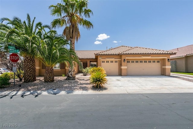1453 Doggett Ave, Las Vegas, NV 89123 - view of front of home with stucco siding, an attached garage, driveway, and a tiled roof