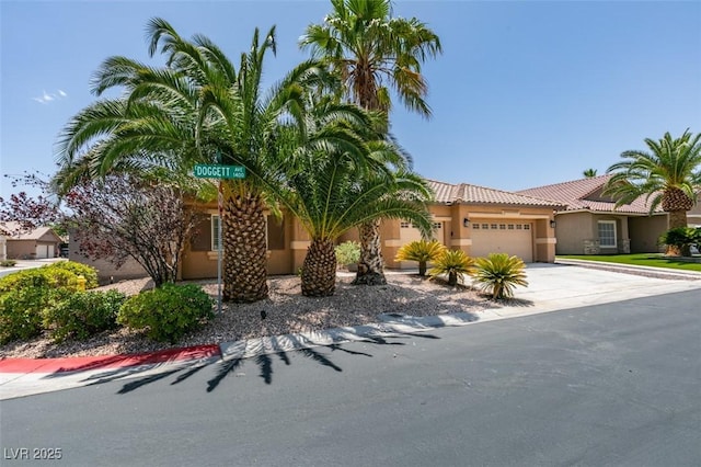 1453 Doggett Ave, Las Vegas, NV 89123 - view of front of house with an attached garage, stucco siding, driveway, and a tile roof