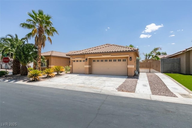 1453 Doggett Ave, Las Vegas, NV 89123 - mediterranean / spanish home with stucco siding, a tiled roof, a garage, and driveway